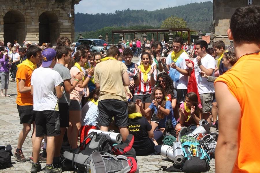 A group of young pilgrims celebrates reaching the square in front of the cathedral in Santiago de Compostela