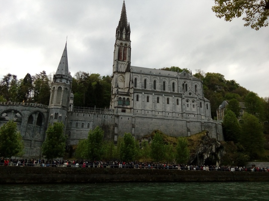 Pilgrims in front of the basilica at the Lourdes sanctuary